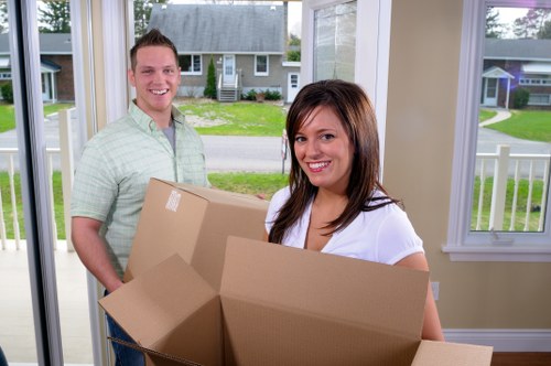Professional movers carrying furniture in a Crystal Palace property