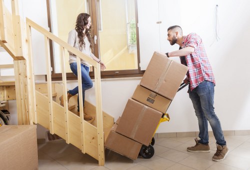 Professional movers handling furniture carefully in a Crystal Palace home