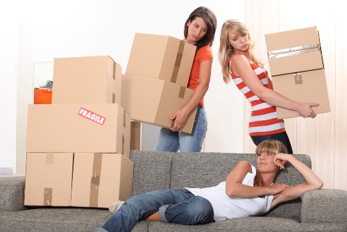 Local movers carrying items from a flat with stairs and narrow access in Crystal Palace